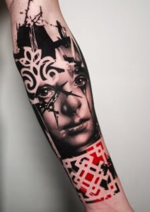 Tattoo sleeve design featuring a detailed black and grey composition of a face with abstract patterns and red accents, showcasing artistry and creativity relevant to Inked Tattoo Studios' offerings.