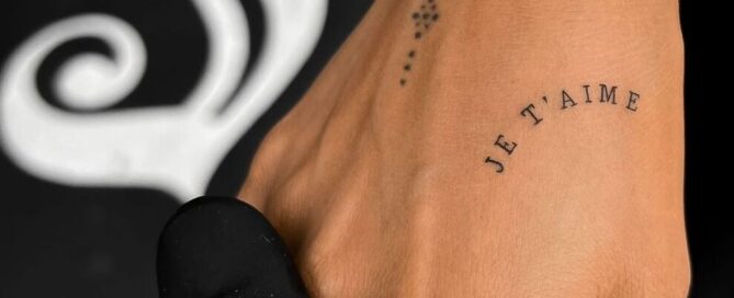 “Je T’aime” tattoo in small text on a hand