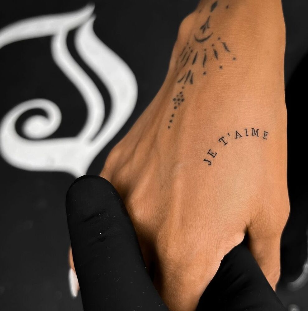 InkedMiamiJuly_Phrase “Je T’aime” tattoo in small text on a hand