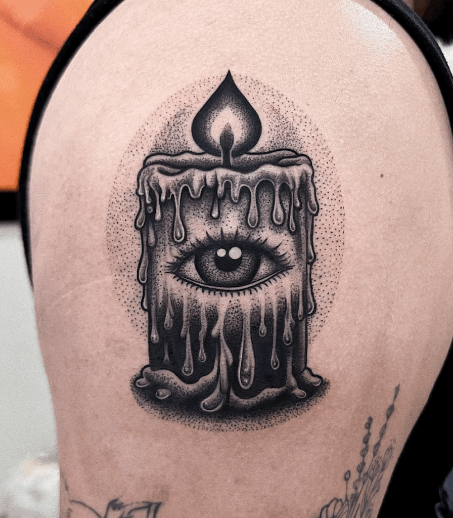Stippled black and grey tattoo of a melting candle with an eye in the center