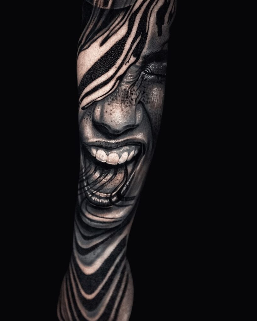 Black and grey tattoo of a realistic face screaming, overlaid with flowing abstract blackwork shapes