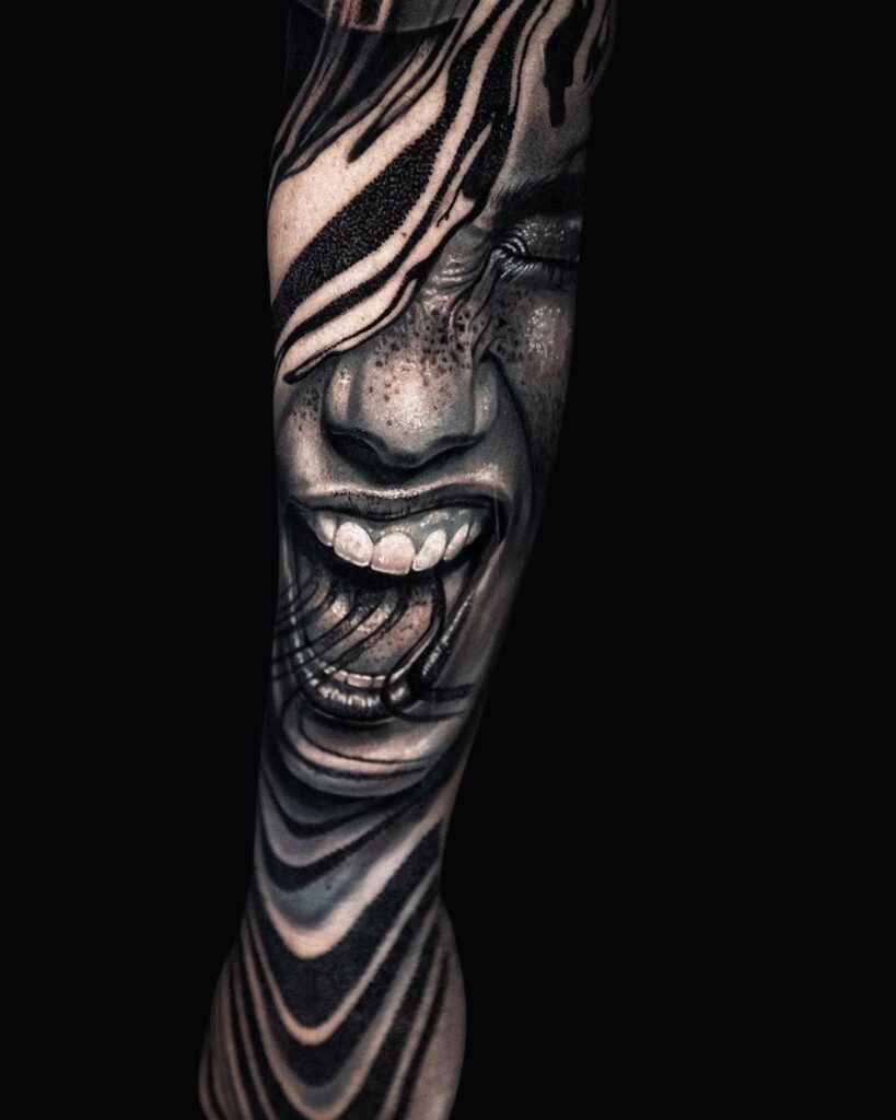 Realistic black-and-gray tattoo sleeve featuring a screaming face distorted by fluid, wave-like blackwork patterns