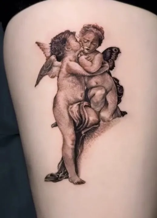 Fine-line classical-style tattoo of two cherubs embracing, rendered with soft shading and sculptural detail.