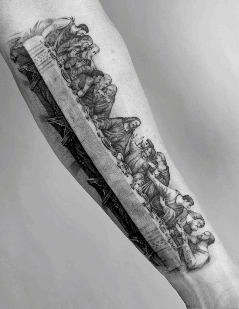 Black and grey forearm tattoo of the Last Supper, featuring detailed shading and realistic figures across the length of the arm.