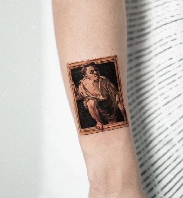 A small, hyper-realistic color tattoo of a young boy in a frame, designed to appear as if he is stepping out of the portrait.
