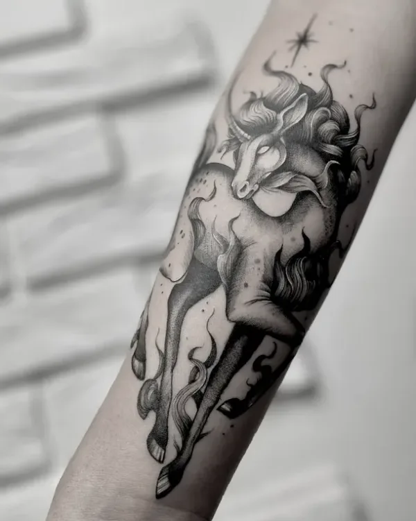 An illustrative black-and-grey tattoo of a unicorn in motion. The piece features soft dot-work shading (stippling), wispy flowing hair, and delicate flames surrounding its legs.