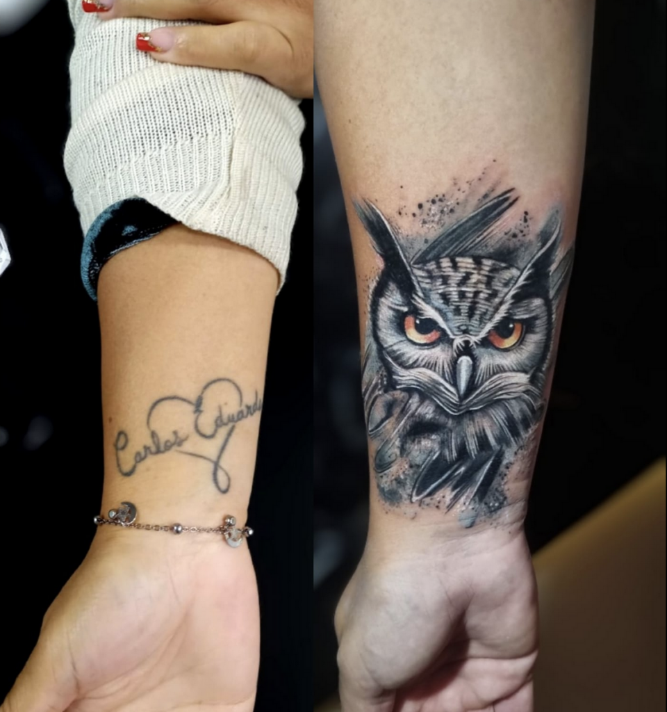 A before-and-after comparison of a wrist tattoo. The left side shows a faded black script name and a simple heart outline. The right side shows the cover-up: a monochromatic, illustrative-style portrait of an owl with bright amber eyes and dark, feathery textures.